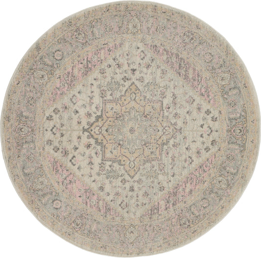 Round vintage-inspired Persian rug in beige-gray with pale pink accents and a delicate central medallion.