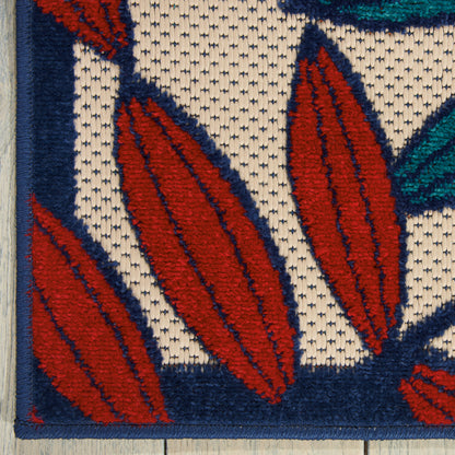 Close-up of a woven rug with red leaf shapes outlined in navy on cream background; blue border and teal accents.