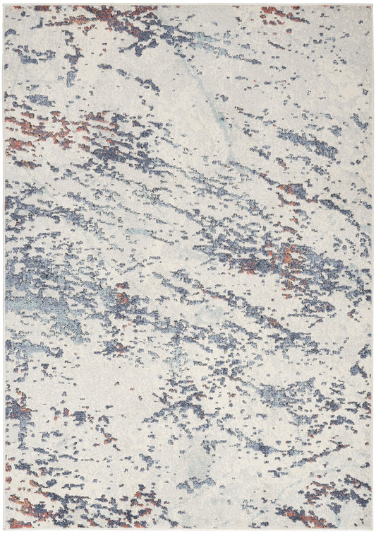 Cream ivory abstract rug with blue-gray and rust speckled pattern.