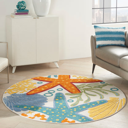 Round ocean-themed rug with orange and blue starfish, shells and seaweed on a bright living room floor.