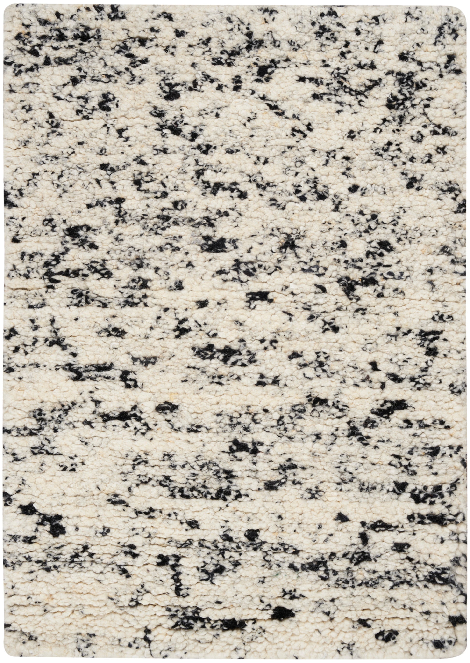 Cream ivory rug with black irregular speckle pattern; plush rounded-corner rectangular area rug for living room.