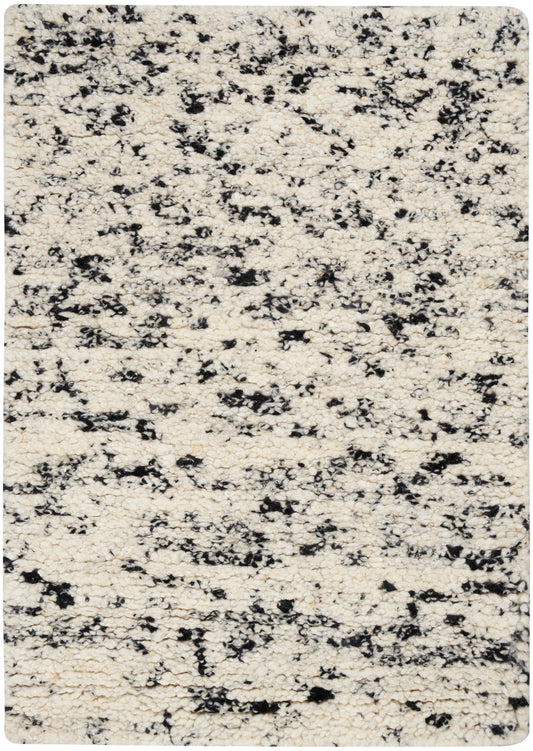 Cream ivory rug with black irregular speckle pattern; plush rounded-corner rectangular area rug for living room.