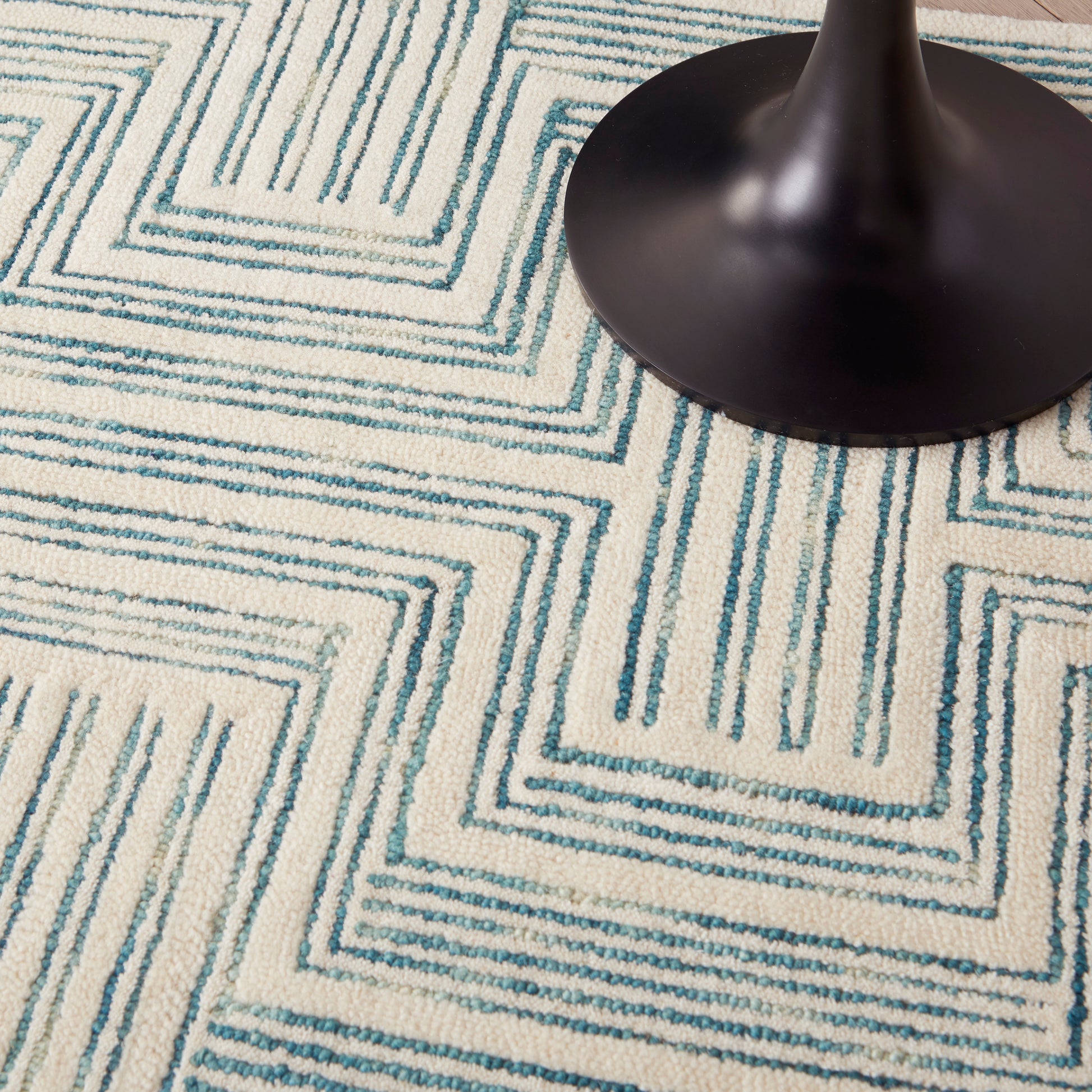 Blue and white geometric woven area rug with a stepped square maze pattern; modern home decor