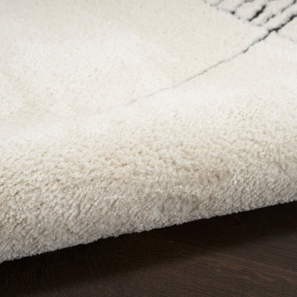 Cream plush shag rug with dense pile on dark wood floor.