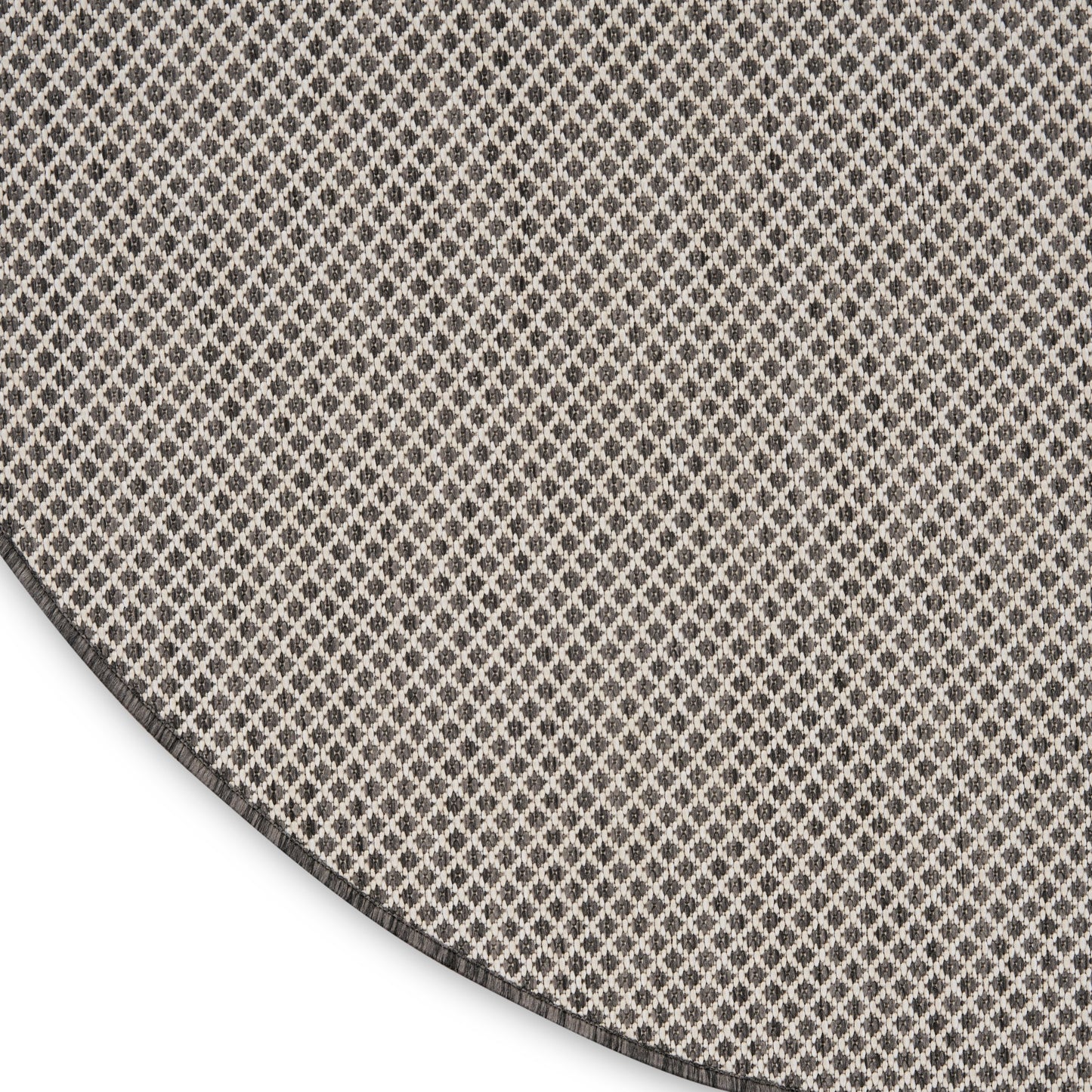 Round rug with small beige & brown diamond lattice pattern, soft textile look, curved edge visible.