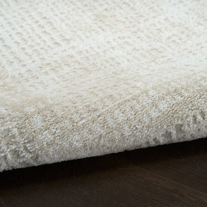 Cream shag rug with dense plush pile on dark wood floor.