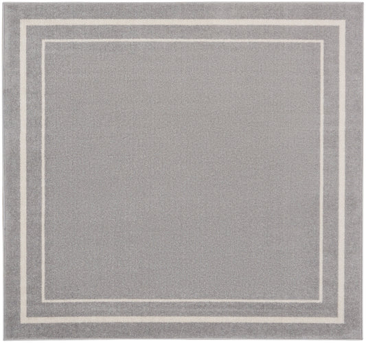 Gray rug with cream nested square borders; modern minimalist style, soft textured pile.