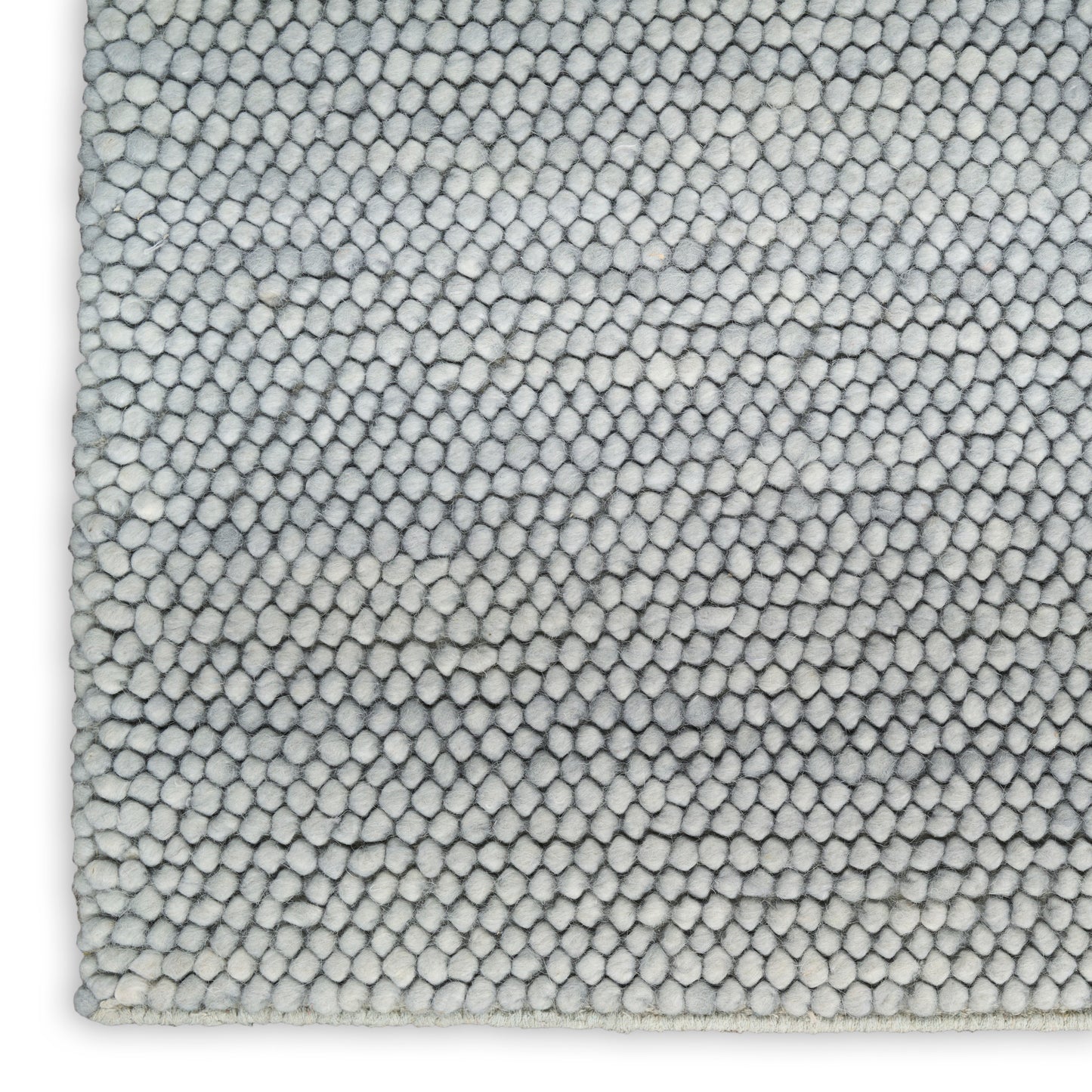 Close-up of light gray boucle rug with dense loop pile; soft, modern rectangular area rug.