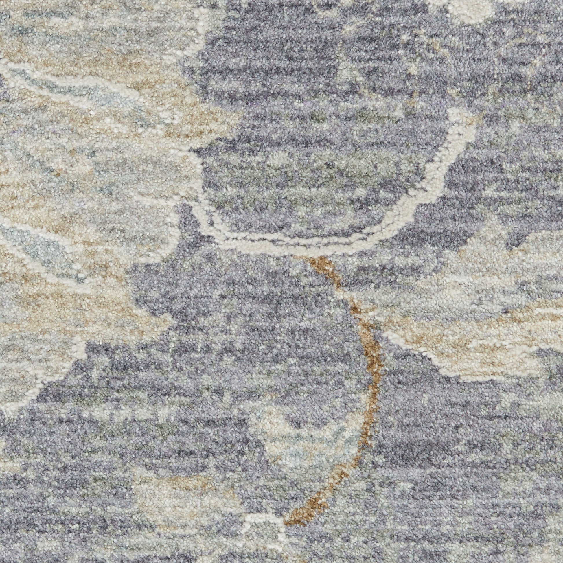 Abstract patterned area rug with soft pile in blue-gray, beige and cream tones with tan curved accent.