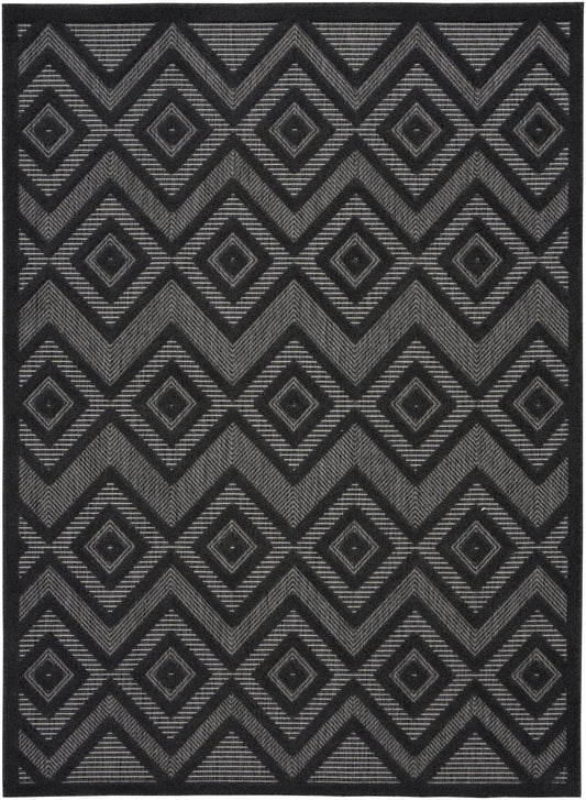 Dark charcoal rug with a repeating gray geometric diamond and chevron pattern in a woven texture.