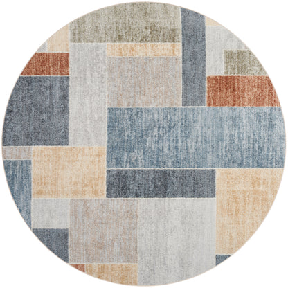 Round patchwork area rug with rectangular blocks in muted blues, beiges, creams, grays, and rust tones.
