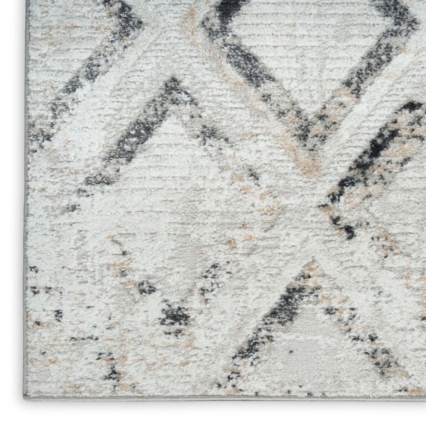 Neutral geometric rug in ivory and gray with charcoal diamond motif; soft tufted pile for living spaces.