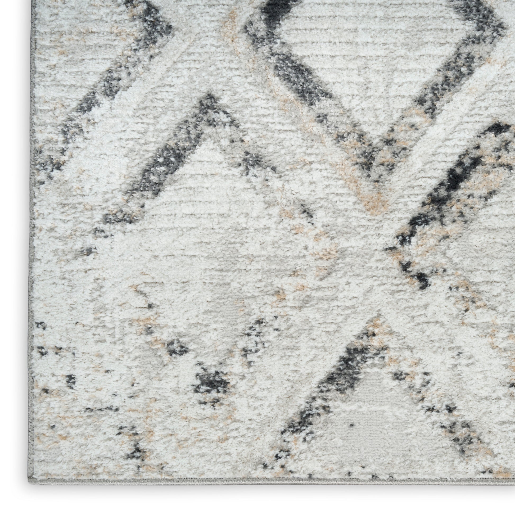 Neutral geometric rug in ivory and gray with charcoal diamond motif; soft tufted pile for living spaces.