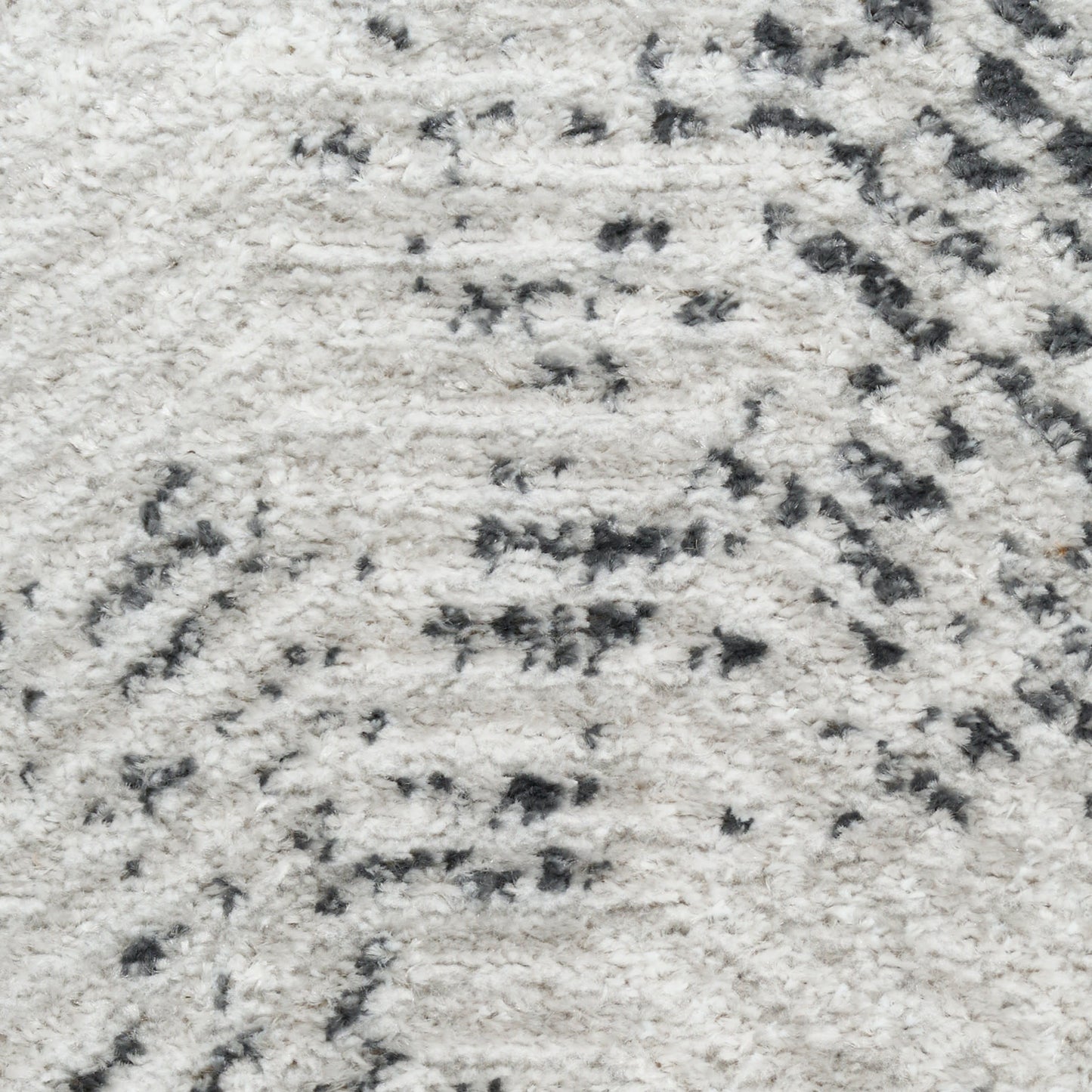 Cream shag rug with dark gray abstract pattern and plush pile.
