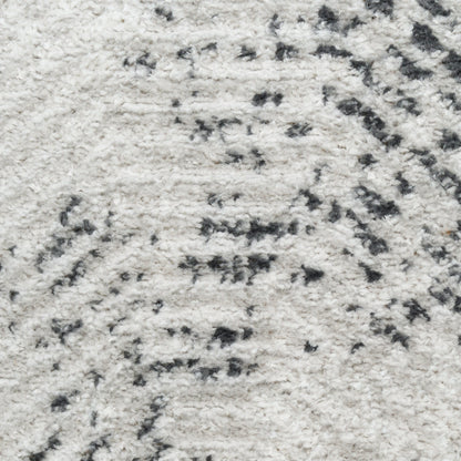 Cream shag rug with dark gray abstract pattern and plush pile.