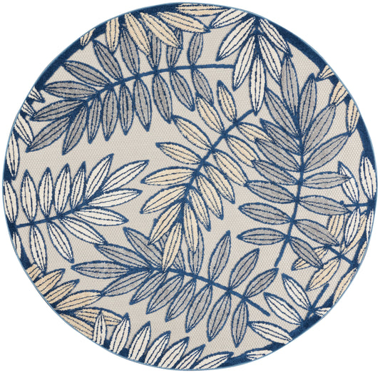Round rug with beige background and navy-blue botanical leaf pattern.