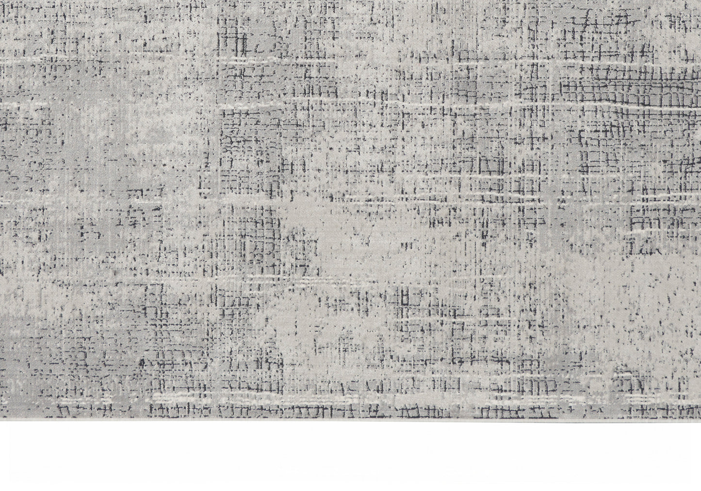 Rectangular area rug in muted gray tones with an abstract distressed pattern and subtle speckling.