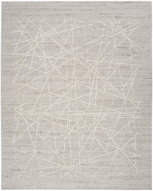 Light gray area rug with white abstract intersecting lines; contemporary woven pattern for living room or bedroom.