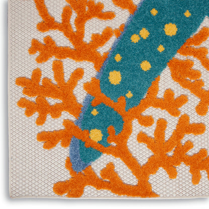Close-up of textured beige rug with bright orange coral motif & teal stripe with yellow dots.
