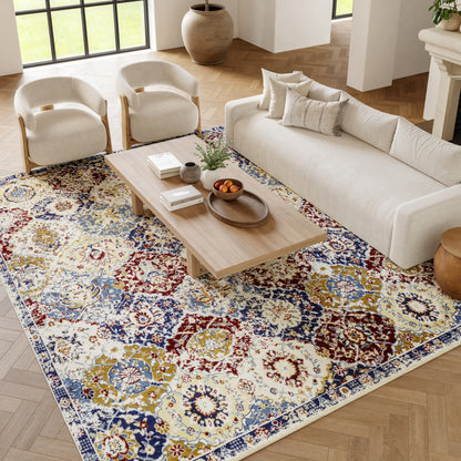Colorful oriental-pattern area rug in blue, red, yellow on light wood floor, with beige sofa, cream chairs, and wooden coffee table.