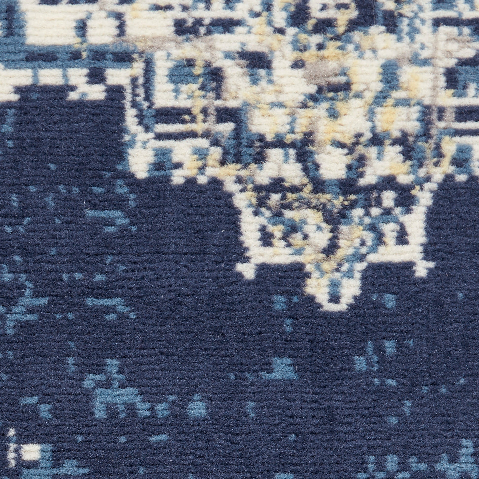 Navy blue area rug with ivory and pale yellow distressed oriental pattern; soft woven pile.