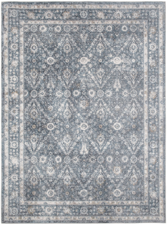 Rectangular blue-gray area rug with ivory floral medallions and ornate border in traditional distressed style.