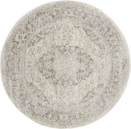 Round beige-gray distressed oriental rug with a vintage medallion motif.