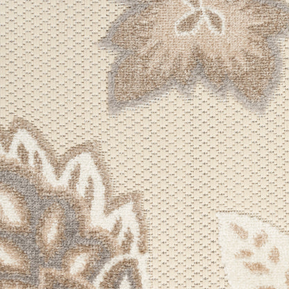 Beige jacquard woven rug with large taupe and cream floral motifs; textured surface.