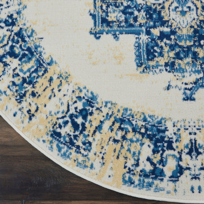 Round area rug with blue, ivory and tan abstract pattern on wood floor