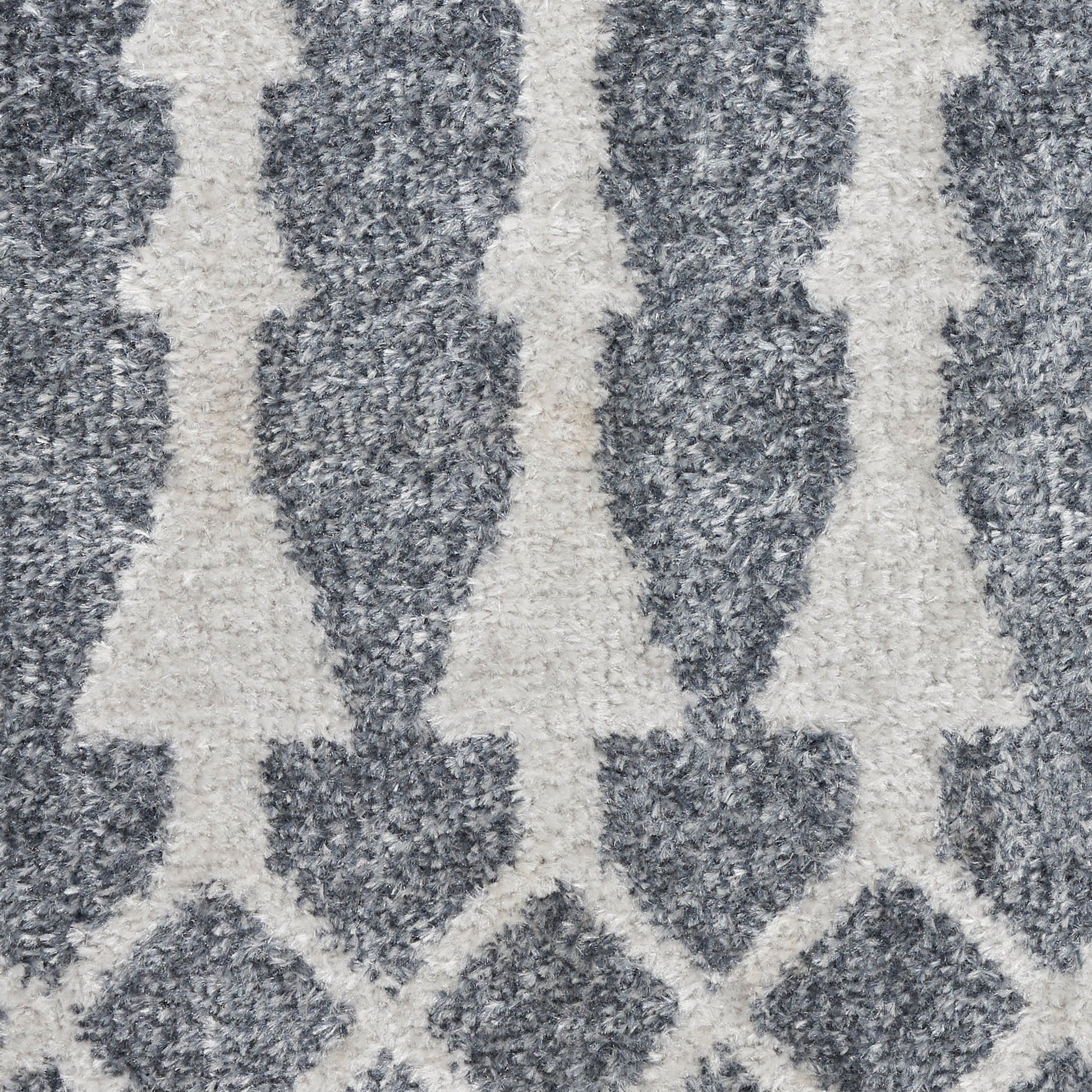 Blue-gray rug with ivory geometric trellis/arrows pattern; plush pile for a modern living room.