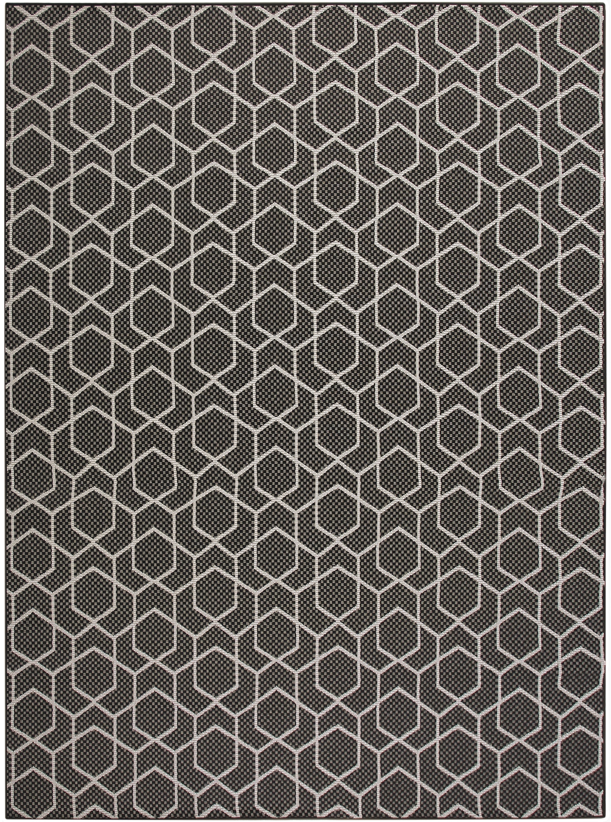 Dark gray area rug with an off-white hexagon lattice pattern and subtle woven texture.