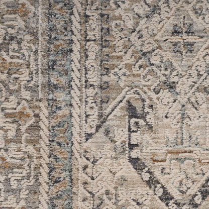 Close-up of a textured woven rug with vintage distressed oriental pattern in ivory, taupe and blue-gray.