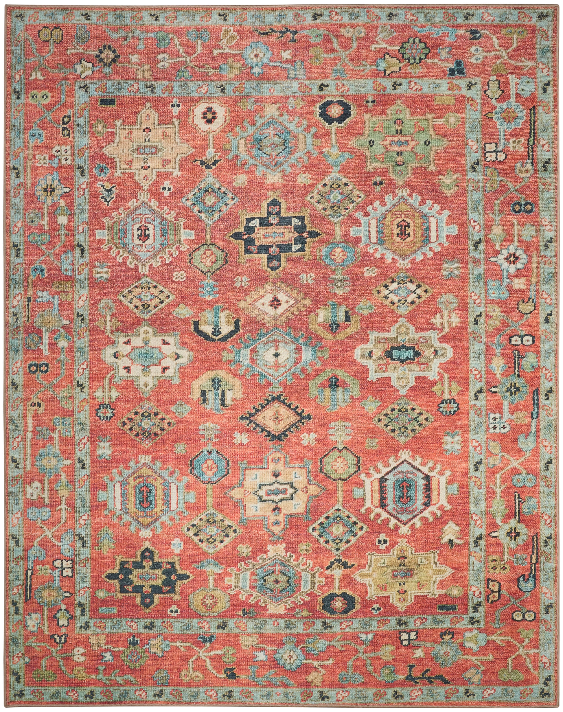 Colorful oriental rug with coral pink field, geometric medallions in blue, ivory, teal; turquoise border with floral motifs.