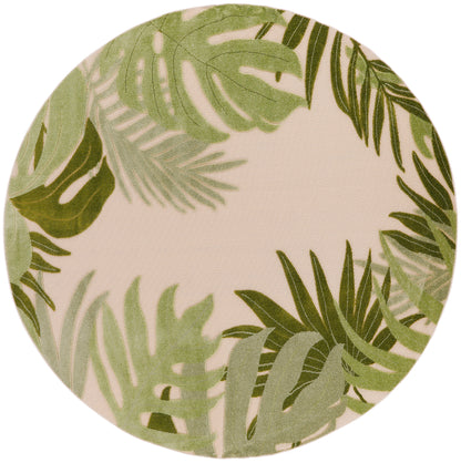 Round beige outdoor rug featuring green tropical palm leaves; botanical style.
