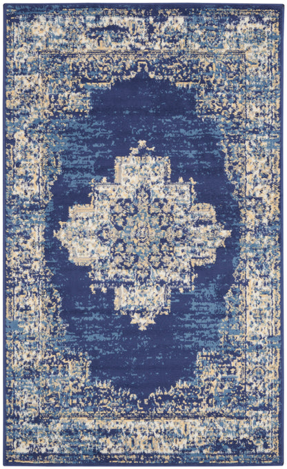 Rectangular blue distressed oriental rug with ivory and gold central medallion and ornate border.