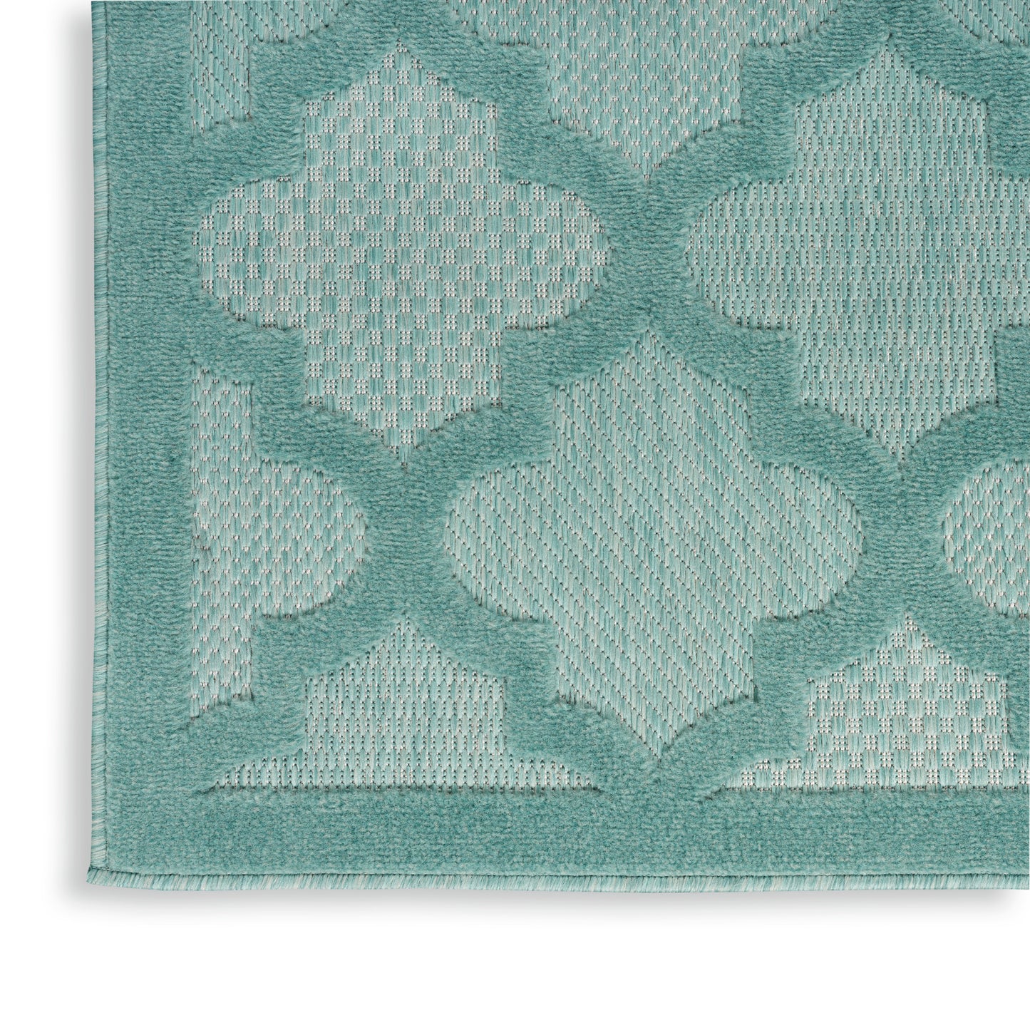 Teal woven rug with raised quatrefoil lattice pattern and matching border.