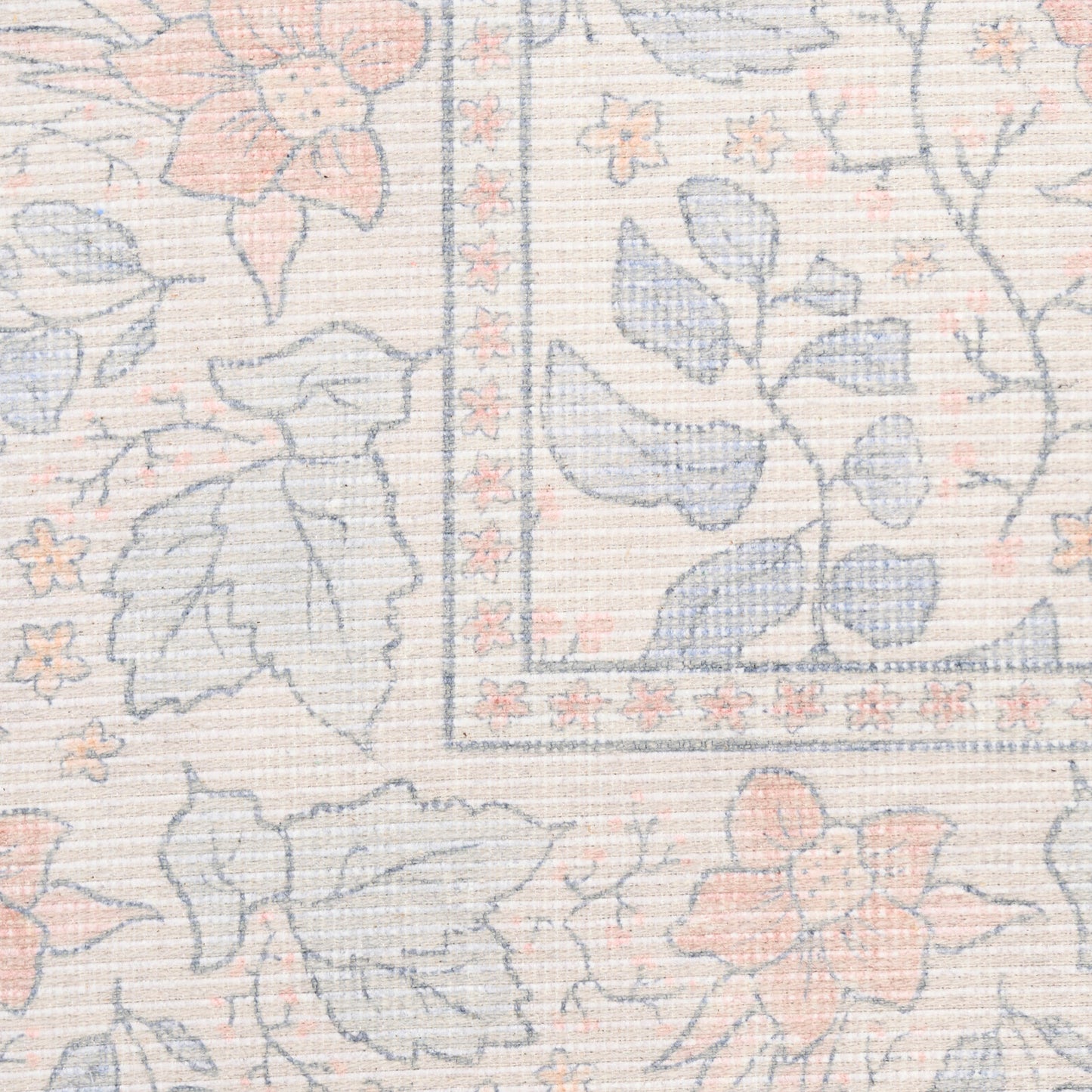 Pastel floral rug with peach and blue blossoms, beige woven background, framed border.