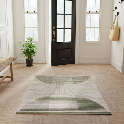 Rectangular flat-weave rug, 5' x 7', with sage green curved arcs on light gray in a modern entryway.