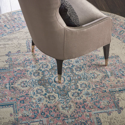 Round vintage beige rug with a pastel pattern; 8' diameter.