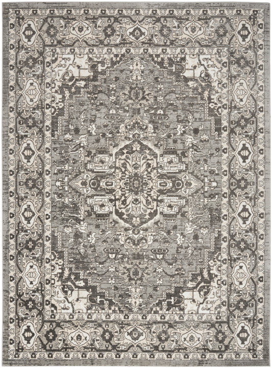 Distressed grayscale Persian-style rug with central medallion and ornate floral border in ivory, taupe & charcoal.