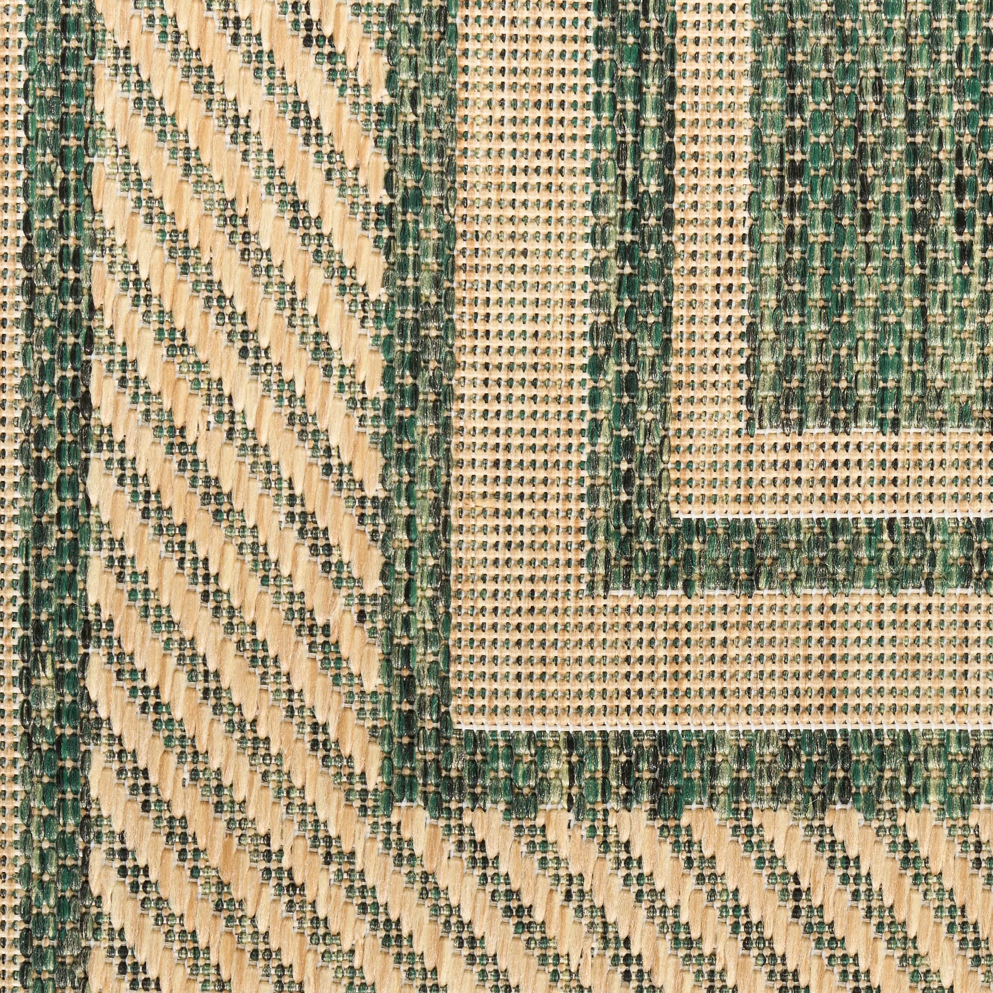 Woven geometric rug in beige and dark green with diagonal stripes and square border motif.