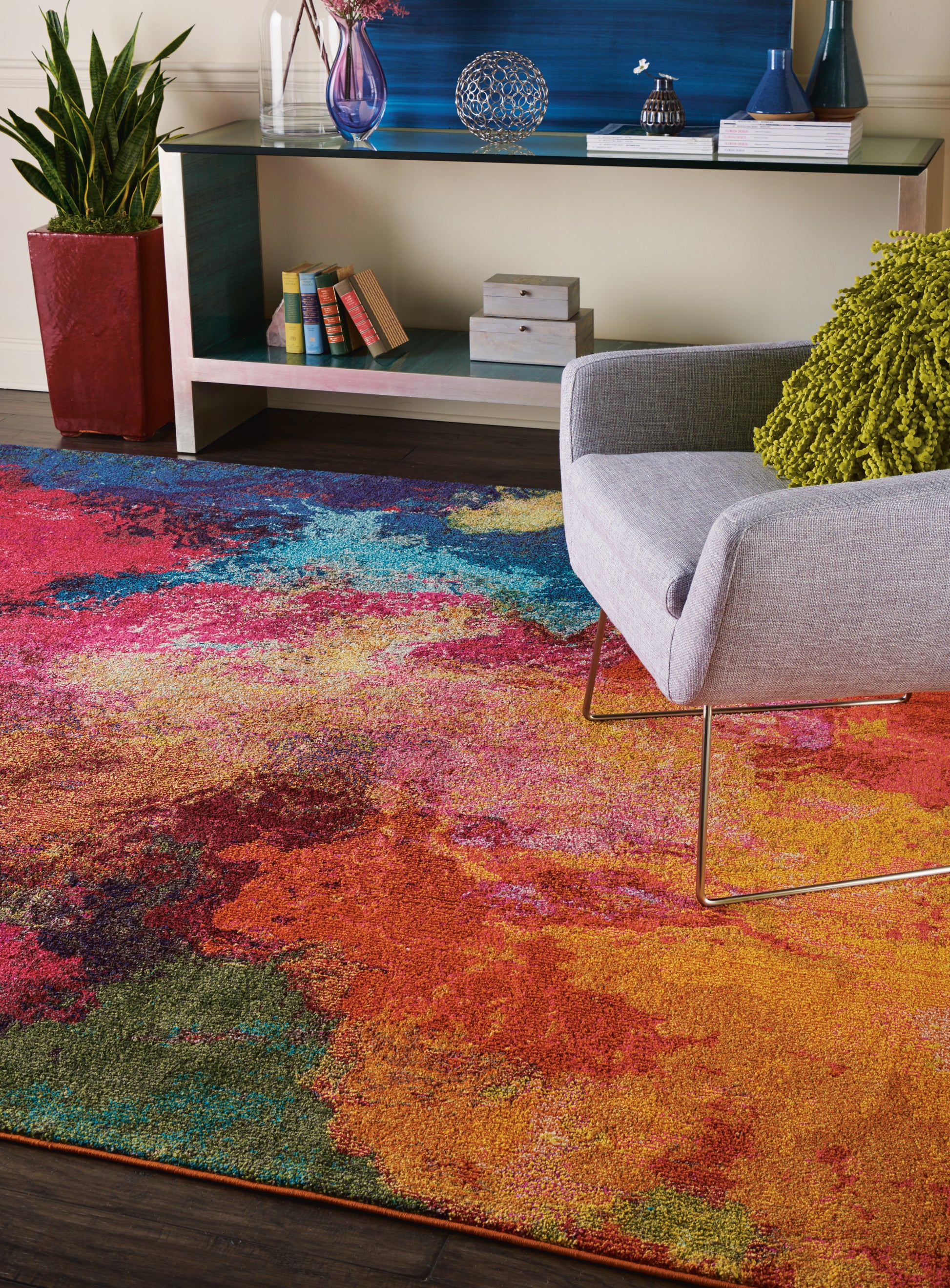 Colorful abstract area rug in orange, pink, blue and green.