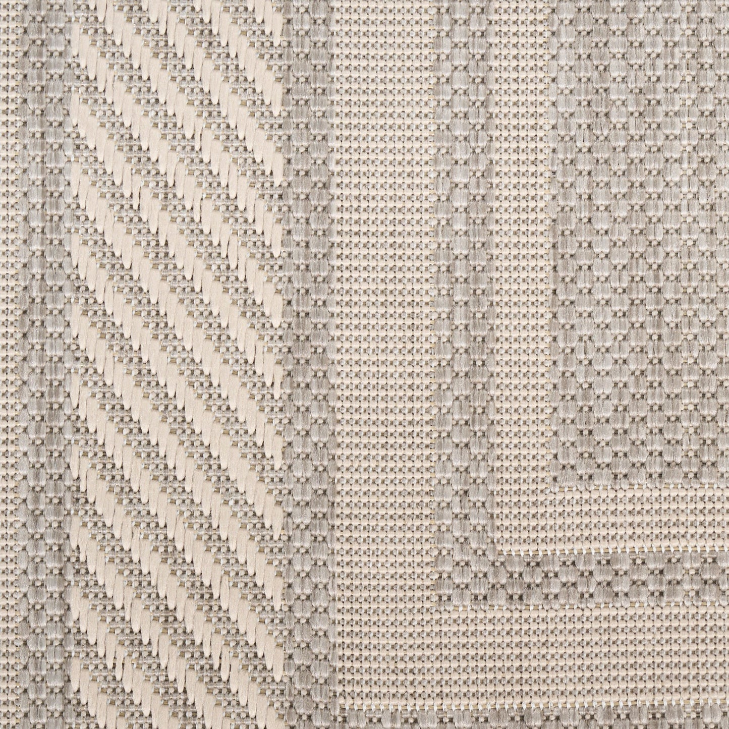 Beige woven rug runner with diagonal chevron pattern on the left and geometric borders; textured neutral textile.