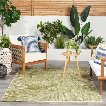 Outdoor rug with a green palm leaf pattern.