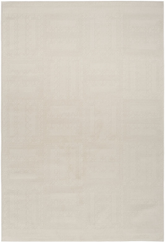 Cream rectangular area rug with subtle geometric patchwork pattern and textured weave.
