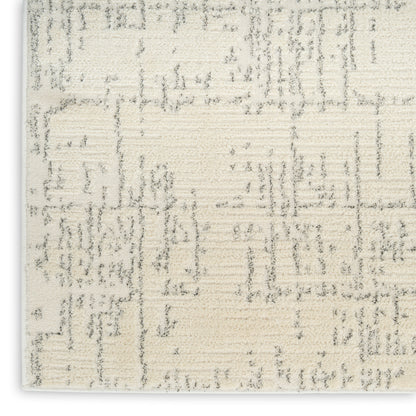 Rectangular cream area rug with subtle grey abstract geometric pattern and a soft, textured weave for modern neutrals.