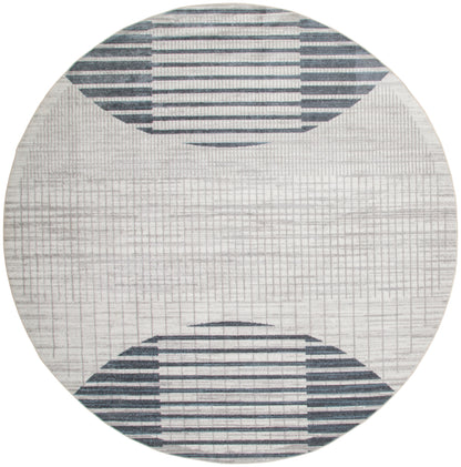 Round rug with light gray base and navy striped semicircles at top and bottom; modern geometric design.