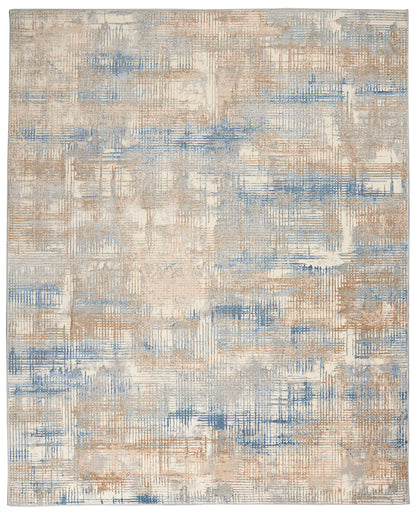Abstract beige and blue area rug with textured patchwork and linear brush-stroke pattern.