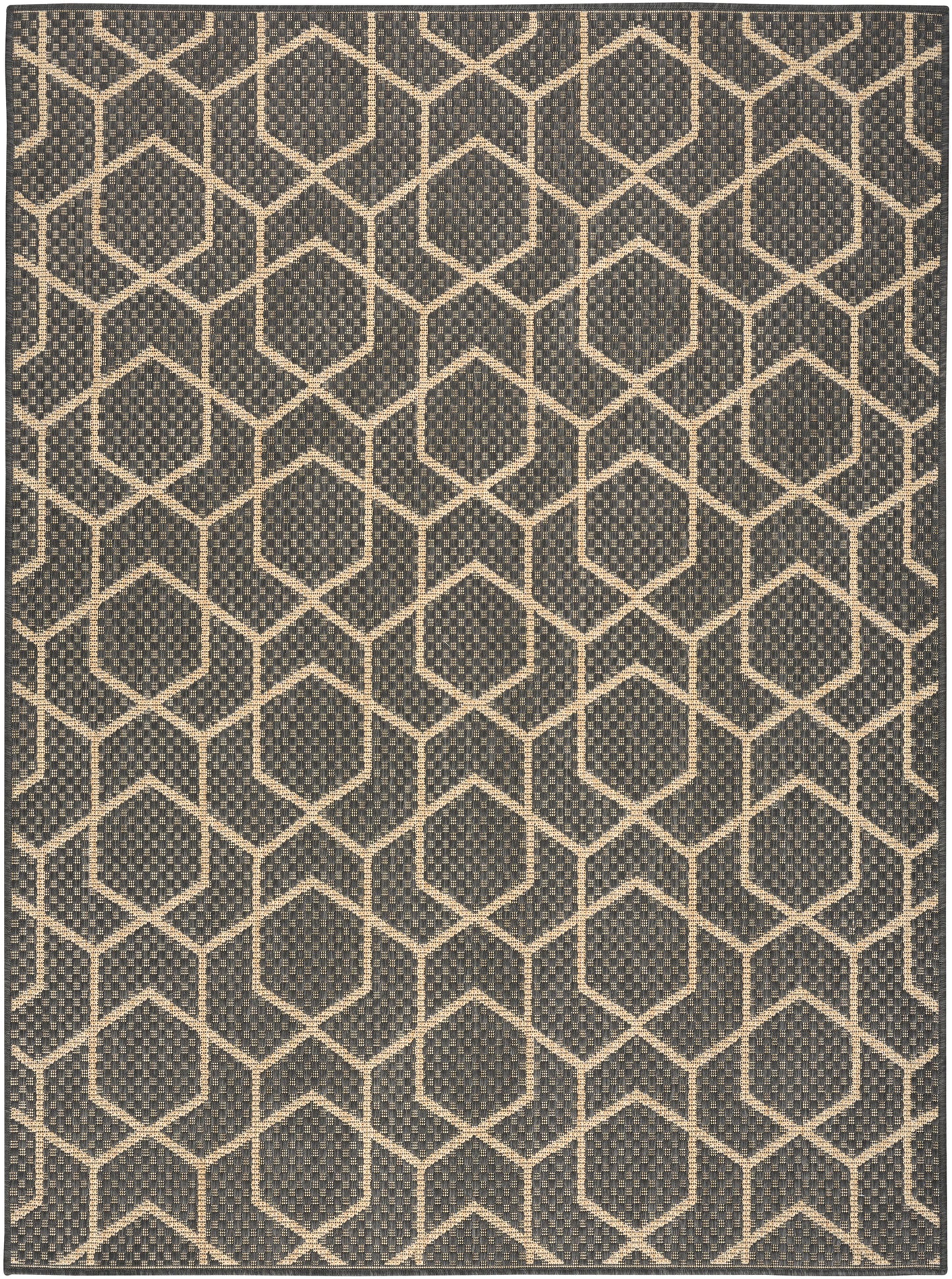Dark charcoal rug with cream hexagon lattice pattern; woven, textured surface in a modern geometric hex grid style.