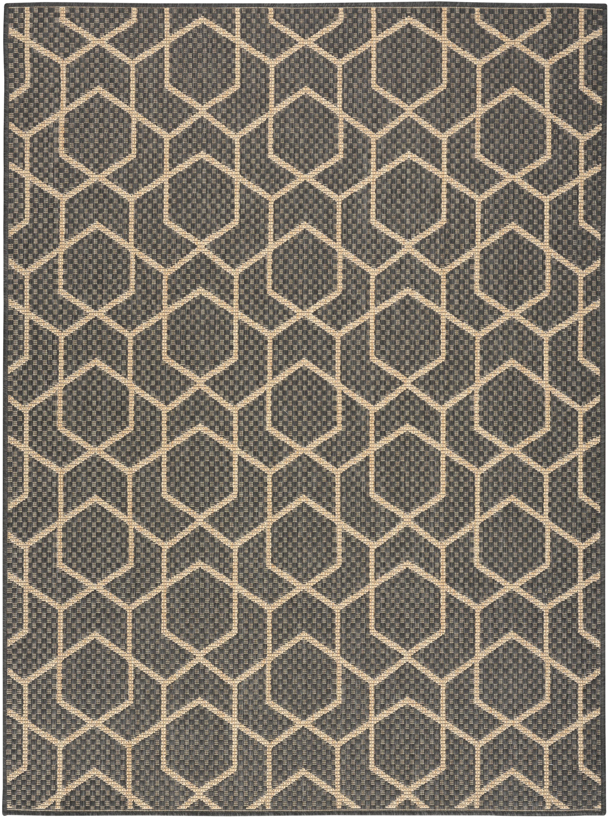 Dark charcoal rug with cream hexagon lattice pattern; woven, textured surface in a modern geometric hex grid style.